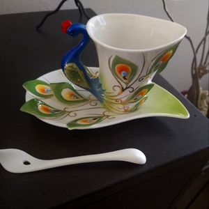 Sculpted glass tea cup and saucer